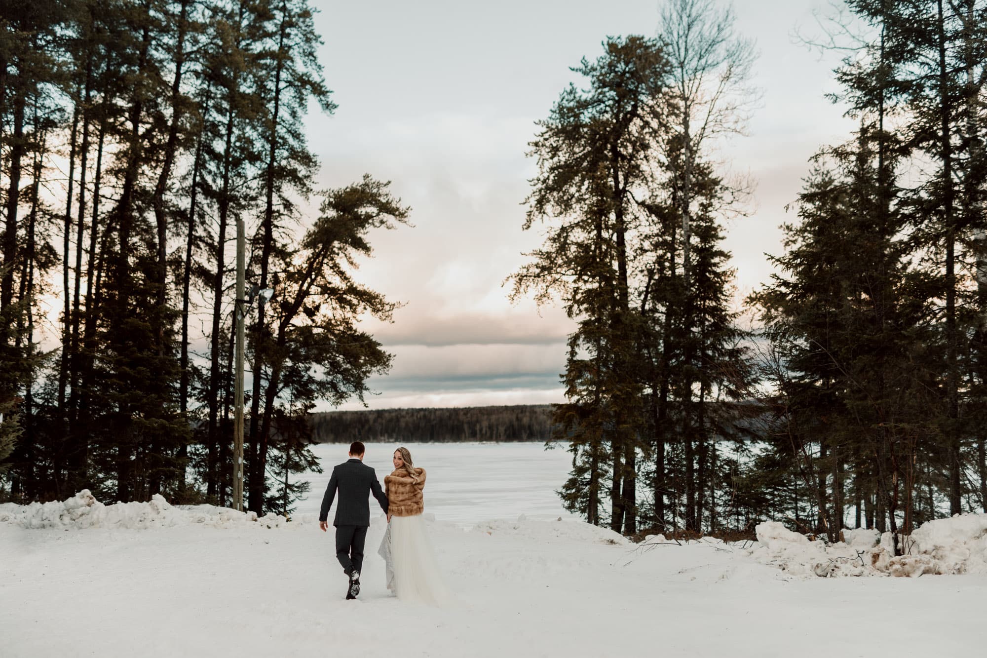 winter wedding bride and groom view lake