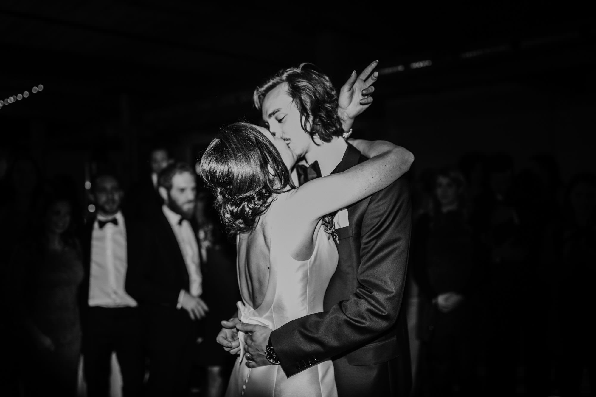 Bride and Groom Kissing during the reception in black and white