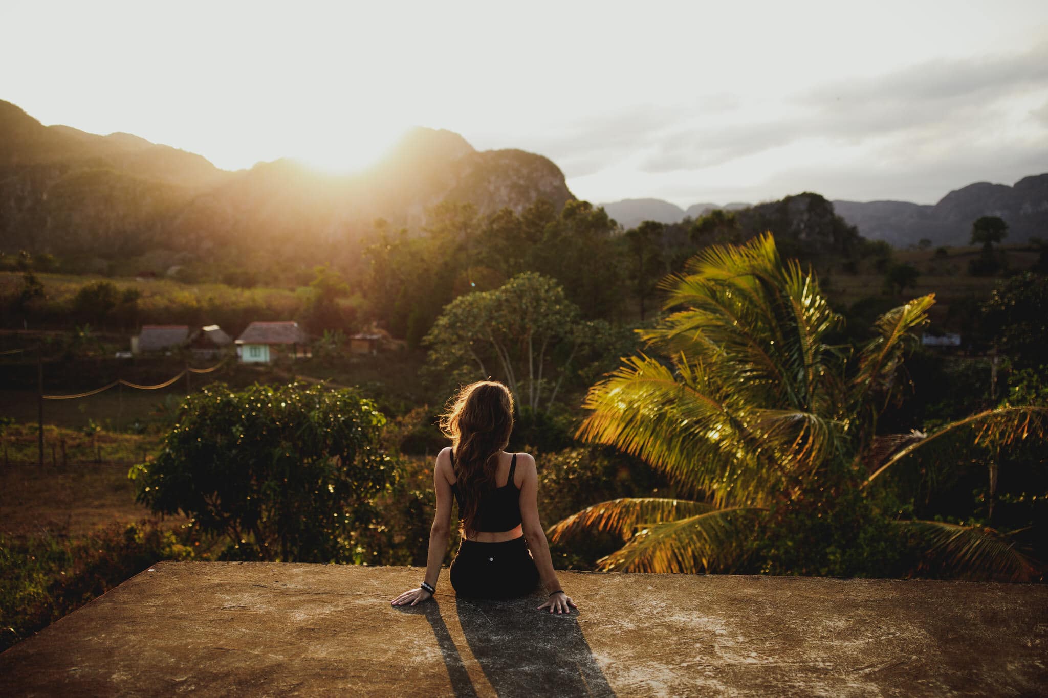 A women enjoying the sunset in the countryside of Vinales, Cuba. Wedding and travel photographer Brent Calis.