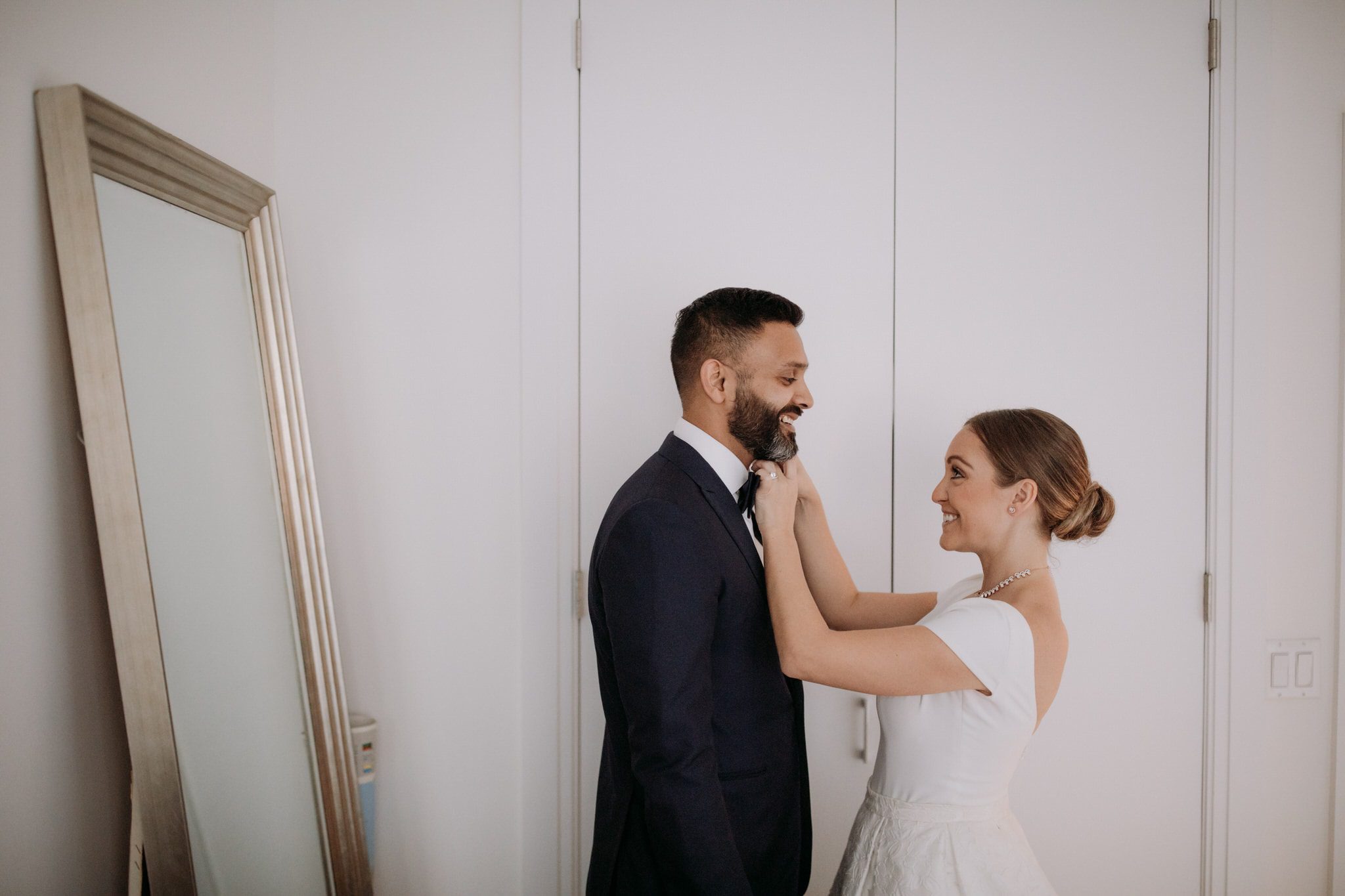 The bride and groom get ready together inside their New York Apartment. Wedding Photographer Brent Calis.