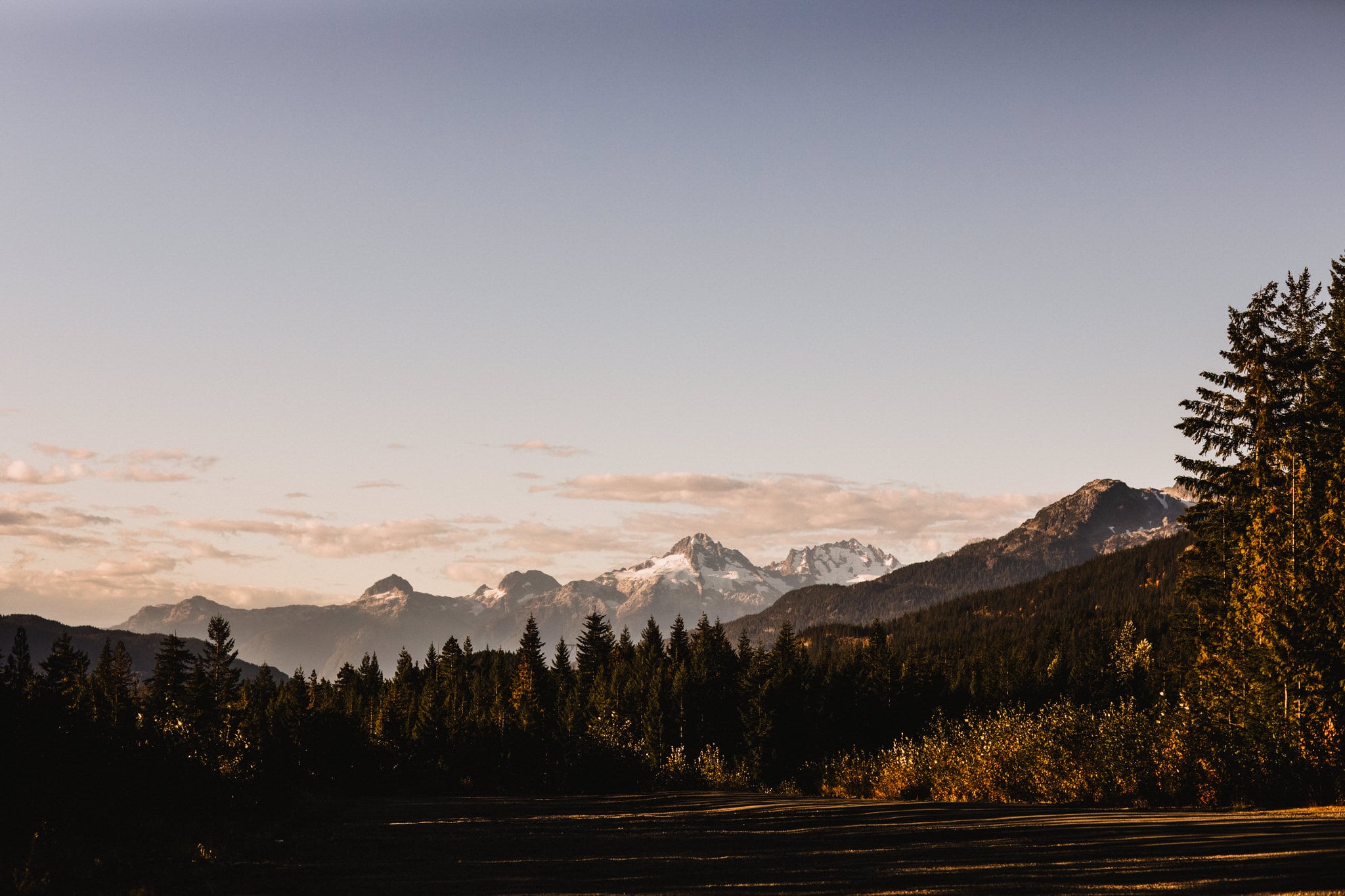Sunrise over the mountains. Forest wedding mountains of Whistler. Destination wedding photographer Brent Calis.