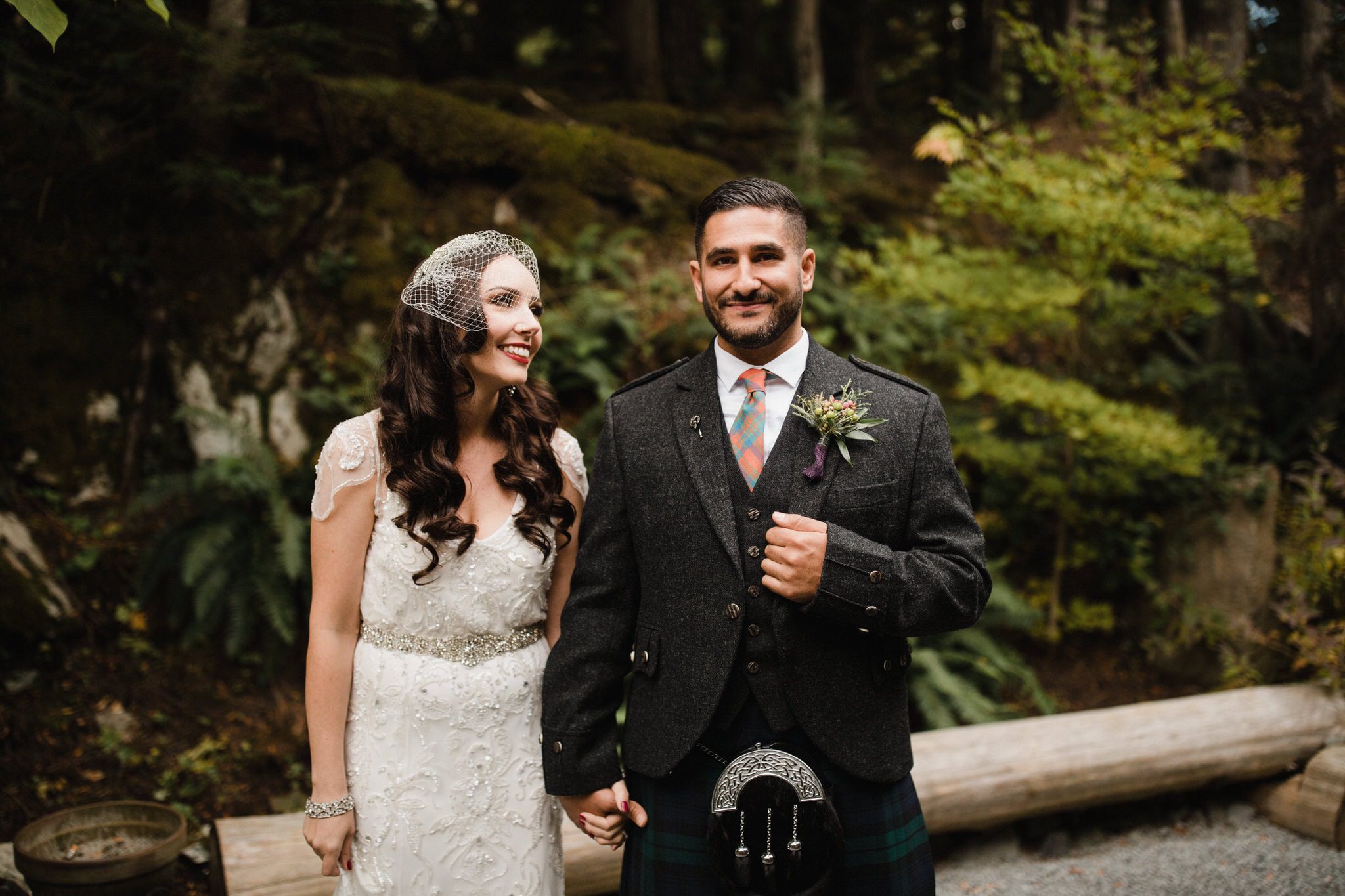 Bride gazes at groom in the forest in the moutinas of Whistler. Destination wedding photographer Brent Calis.