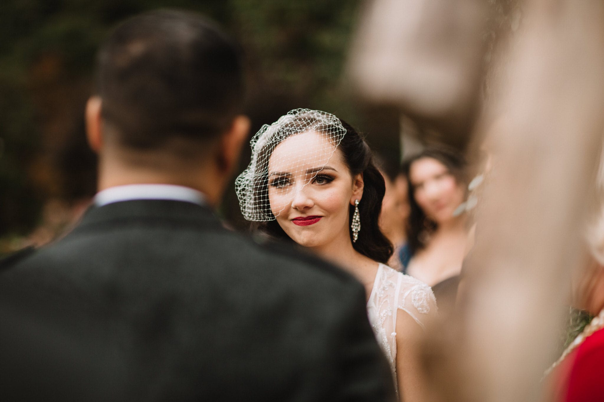 Bride smirks at groom during Whistler wedding. Destination wedding photographer Brent Calis.