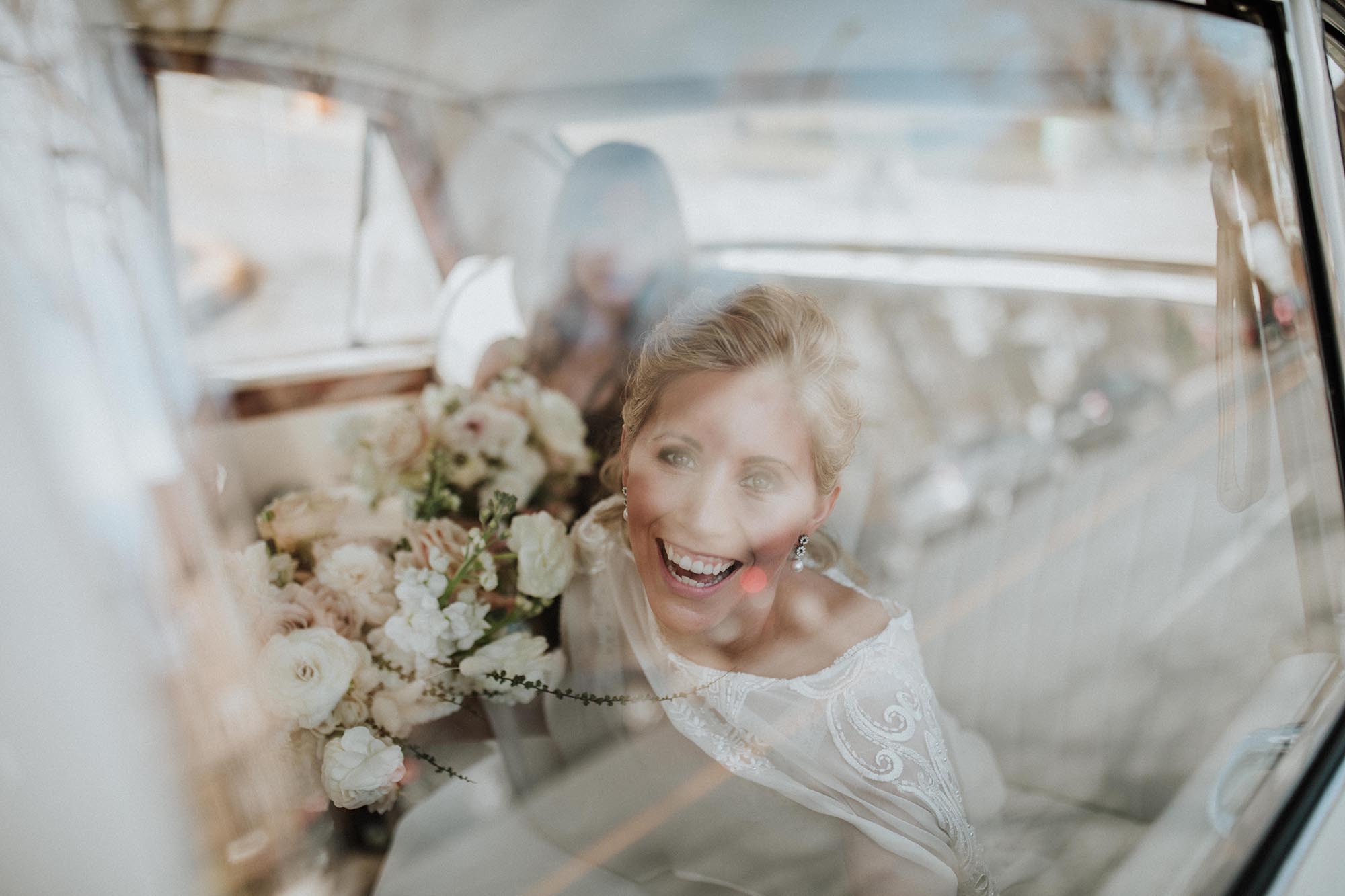 Entrepots Dominion Wedding In Montreal - Bride and groom relax in luxury car - Wedding Photographer Brent Calis